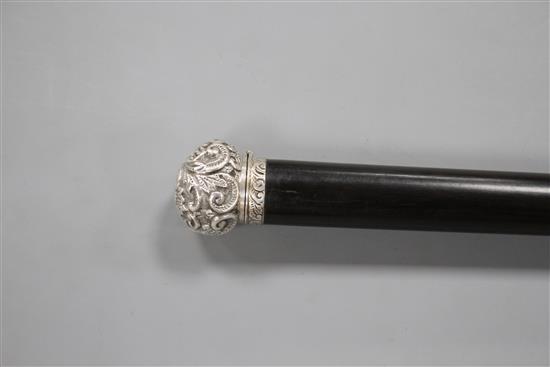 A Victorian walking stick with embossed silver pommel H.M., Birmingham 1906, opens to reveal a compass, overall length 89.5cm